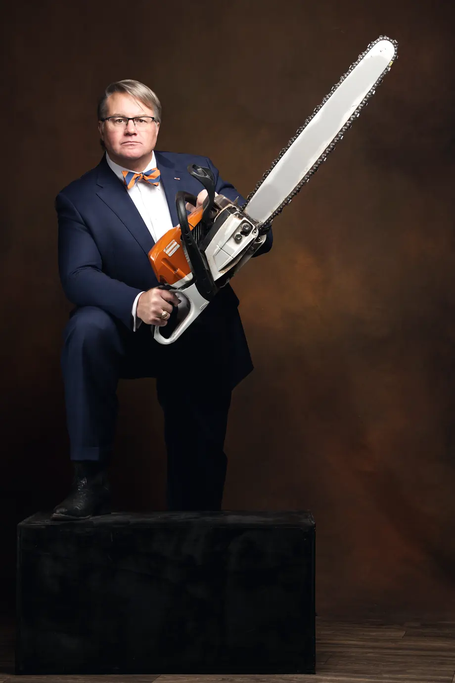 Mark Braswell holding a chainsaw, ready to work
