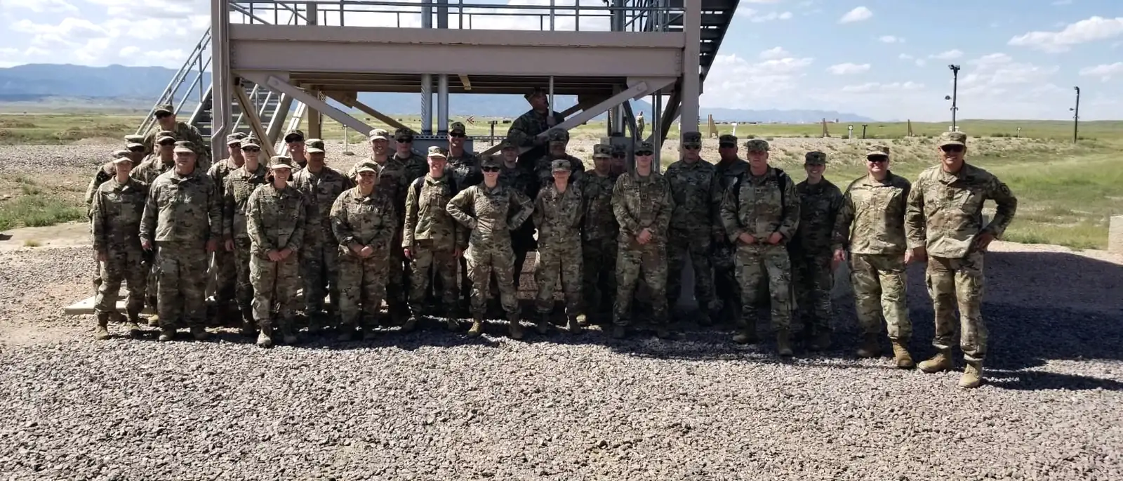 Colonel Braswell with a formation of soldiers at a training site